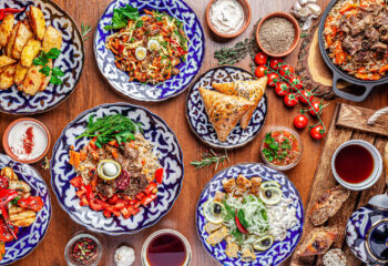 Traditional Uzbek oriental cuisine. Uzbek family table from different dishes for the New Year holiday. The background image is a top view. Traditional Uzbek oriental cuisine. Uzbek family table from different dishes for the New Year holiday. The background image is a top view.